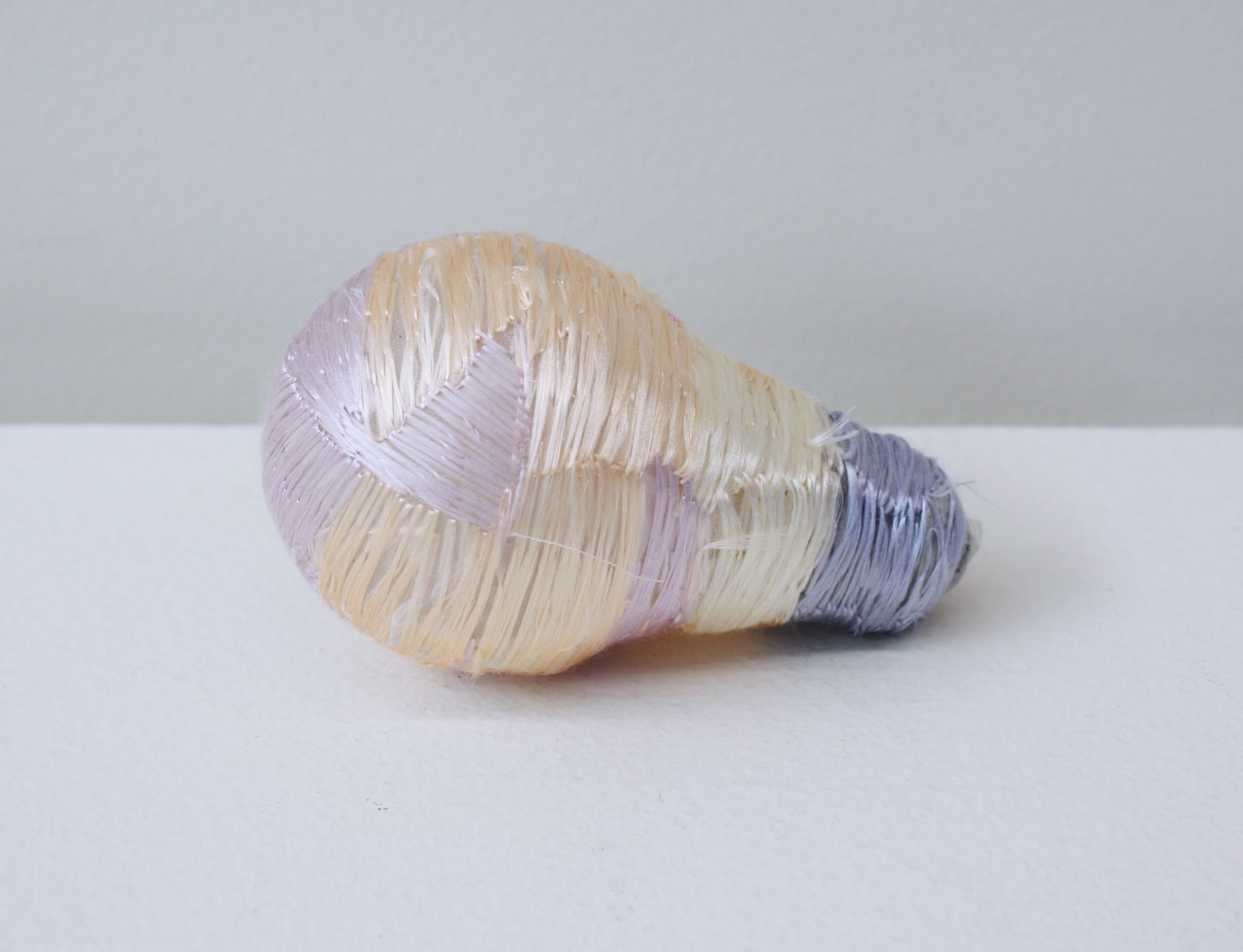 ‘Renovated light bulb purple’, 2012, light bulb, Italian synthetic cloth, Japanese silk thread, 10H x 6D cm