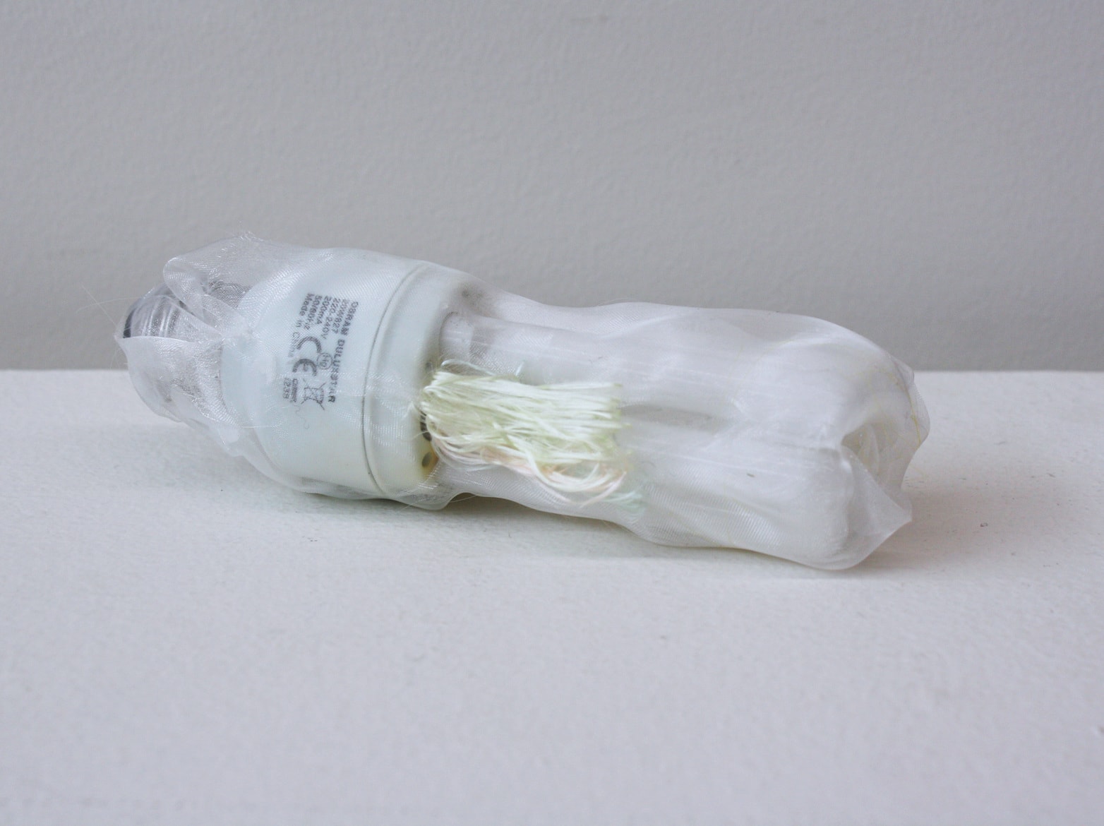 ‘Renovated eco-light bulb’, 2014, light bulb,  Italian synthetic cloth, Japanese silk thread, 15 H x 5D cm