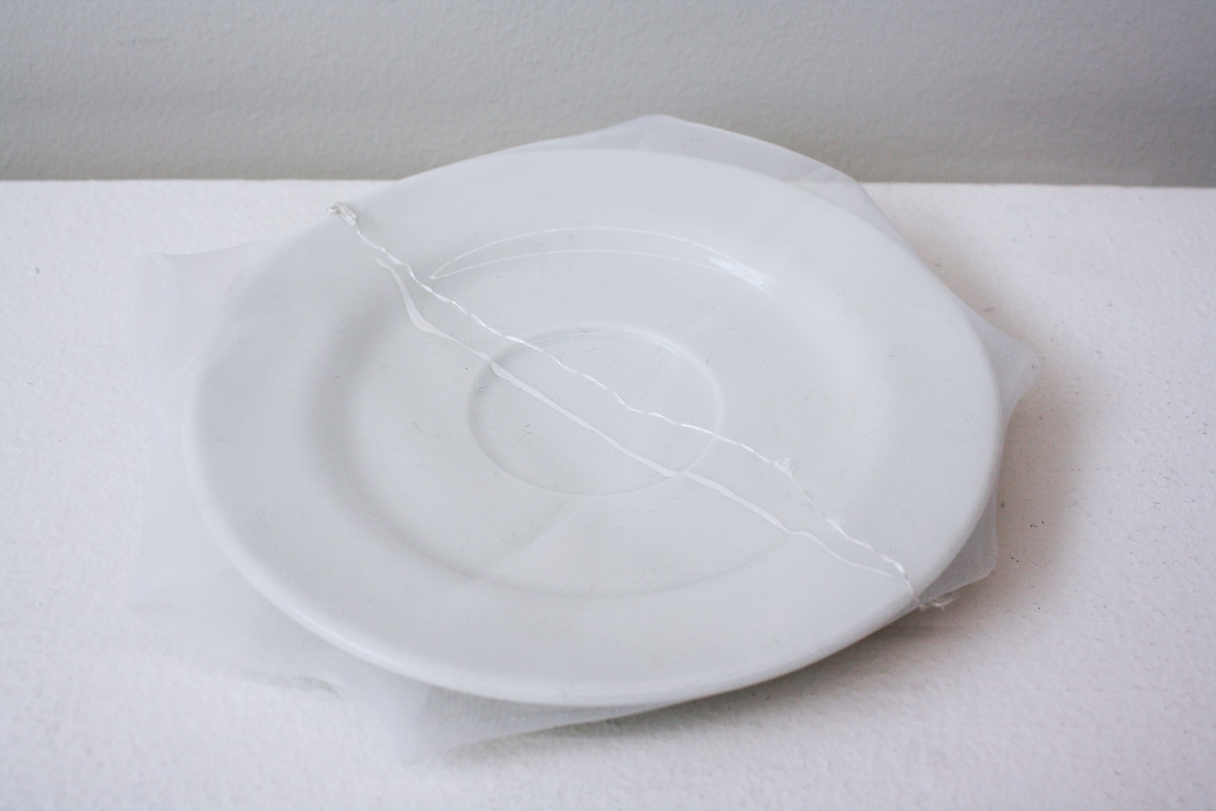 ‘Renovated K.K.'s soup dish’, 2013, ceramic dish, Italian synthetic cloth, Japanese silk thread, 2H x 16D cm